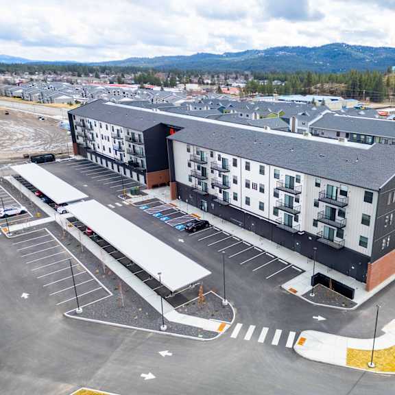 a large building with a parking lot in front of it.