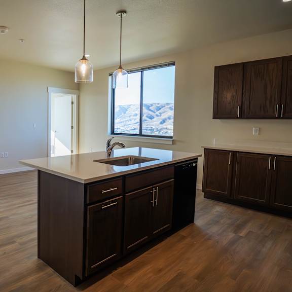 a kitchen with dark wood cabinets and a large island.