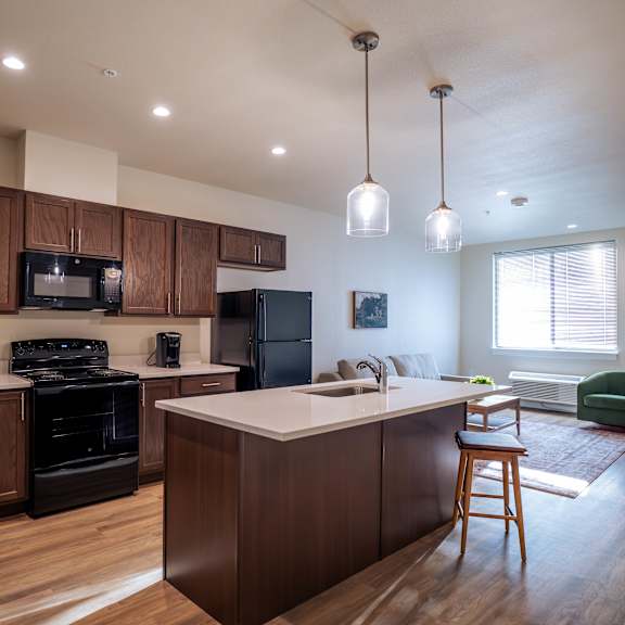 a kitchen with dark wood cabinets and a white countertop.