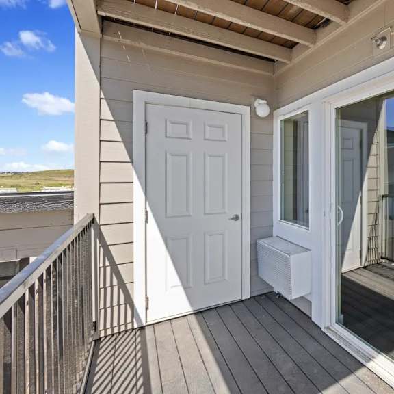 the door to the balcony is open to the patio