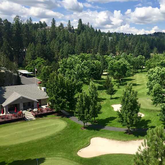 a golf course with a green and a sand trap.