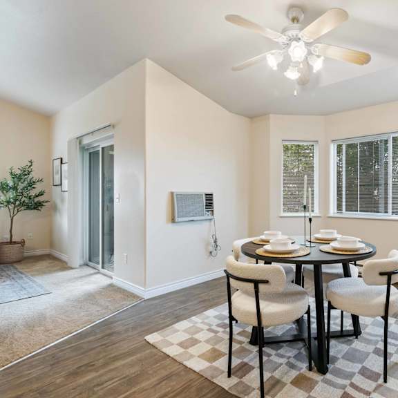 a dining room with a table and chairs and a ceiling fan