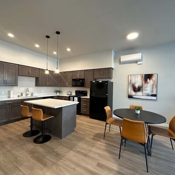 a modern kitchen with a dining table and chairs.