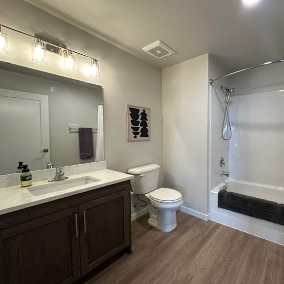 a bathroom with a white toilet and a white shower curtain.