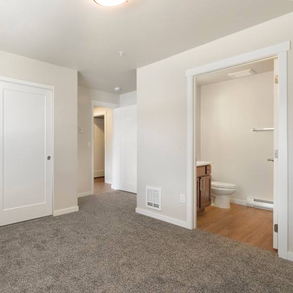 a large, empty room with a carpeted floor and white walls.