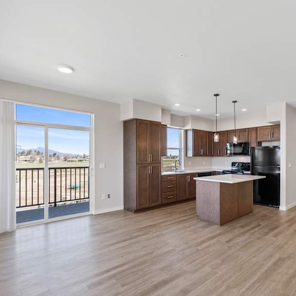 a spacious kitchen with wooden floors and modern appliances.