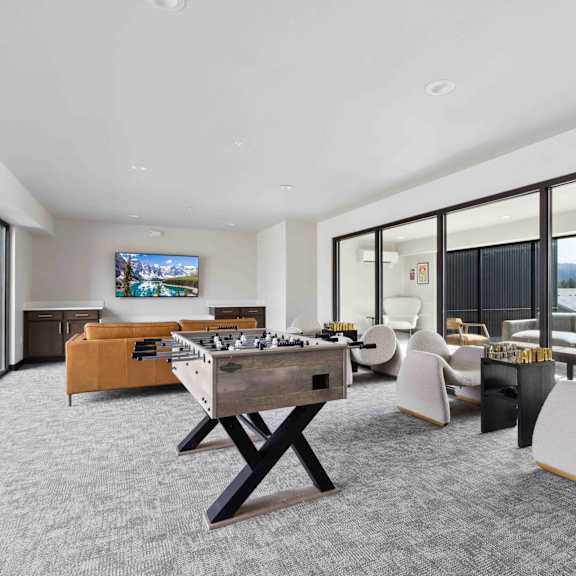 a room with a foosball table and a couch.