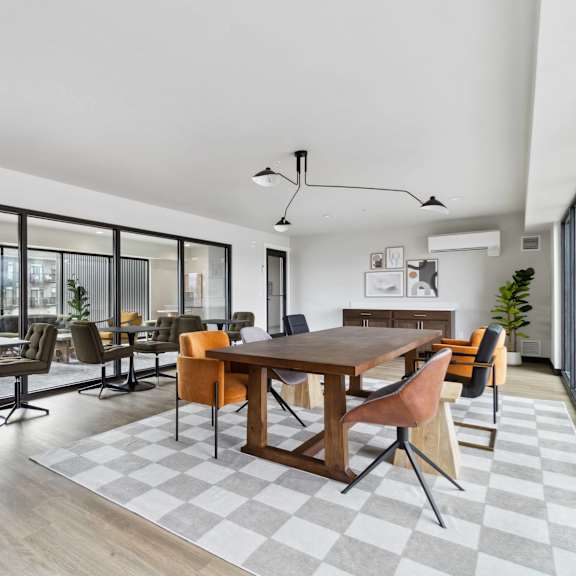 a modern dining room with a large table and chairs.
