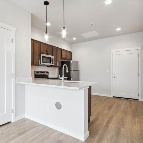 a kitchen with white cabinets and a white island.