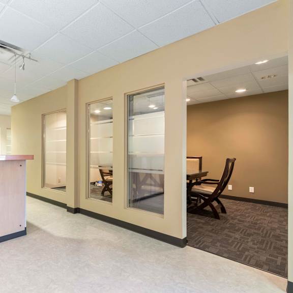 a room with chairs and a counter and a table