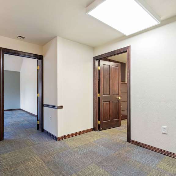 a empty room with a door to a hallway and a closet