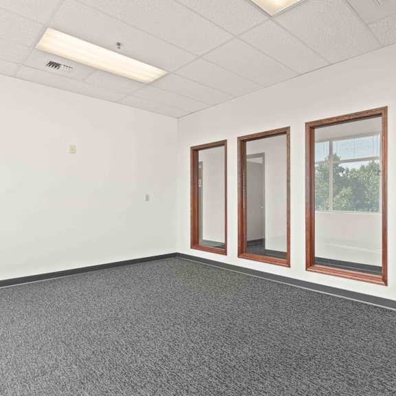 this office space is empty and has windows