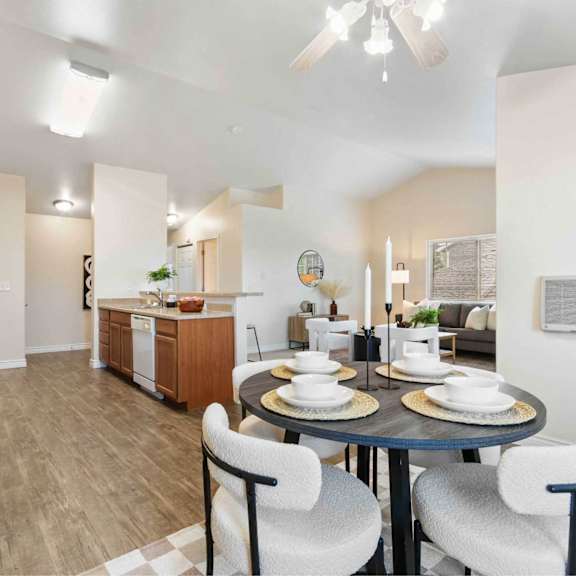 a modern kitchen with a dining table set for two.