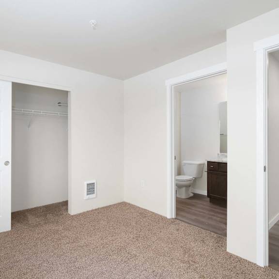 a white door is open to a room with a toilet and sink.
