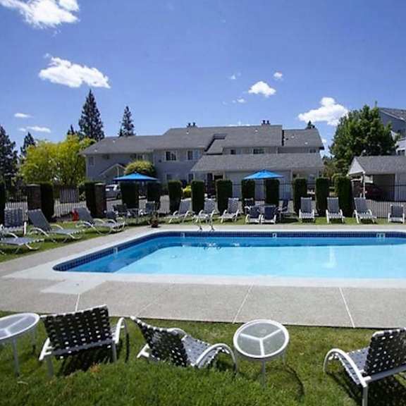 a swimming pool with chairs and chairs around it