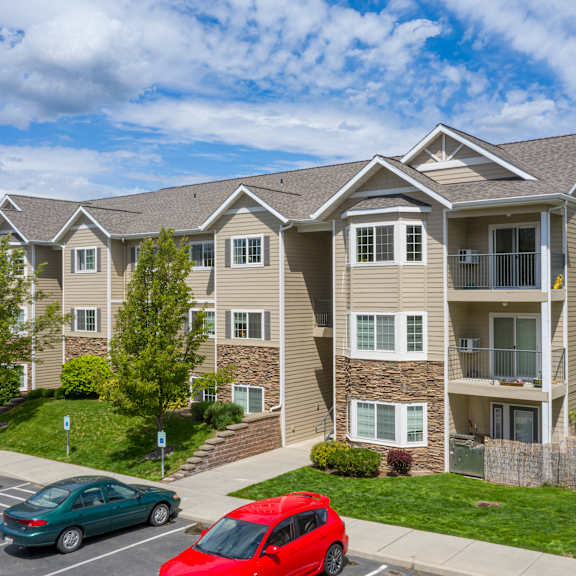country vista at liberty lake apartment building with cars parked in front of it