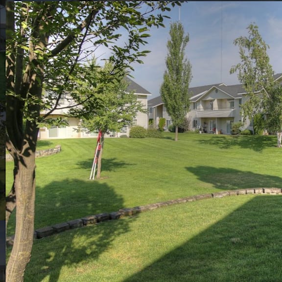 apartment on a hill with grass and trees