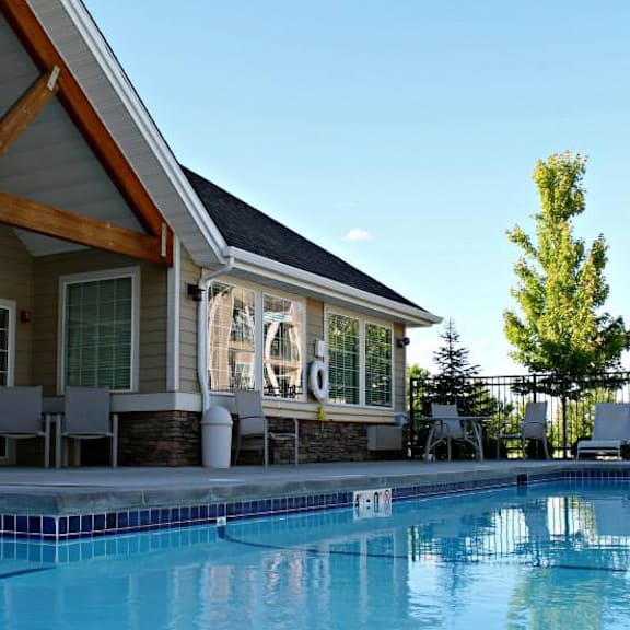 a swimming pool in front of country vista clubhouse with a resort style pool