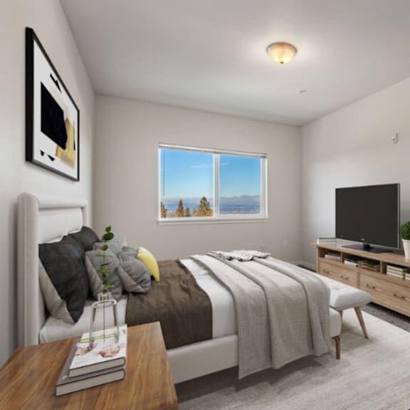 a bedroom with a bed, a television, and a window overlooking the mountains.