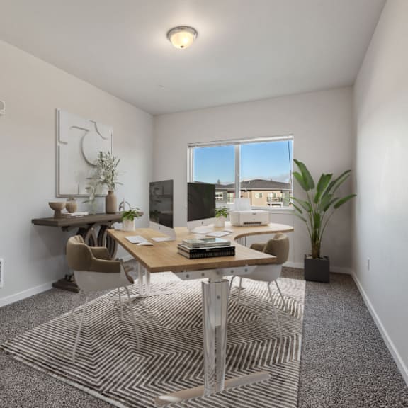 a room with a desk, chairs, and a window.