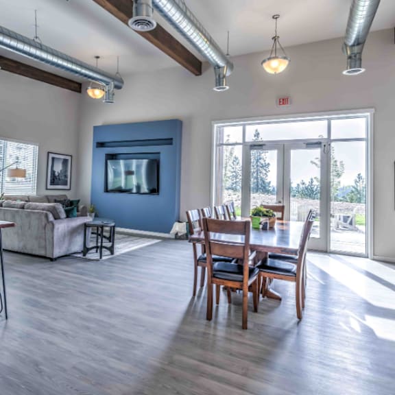 a spacious living room with a dining area and a television.