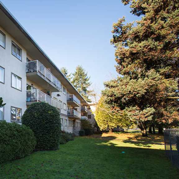 a large grassy area in front of an apartment building