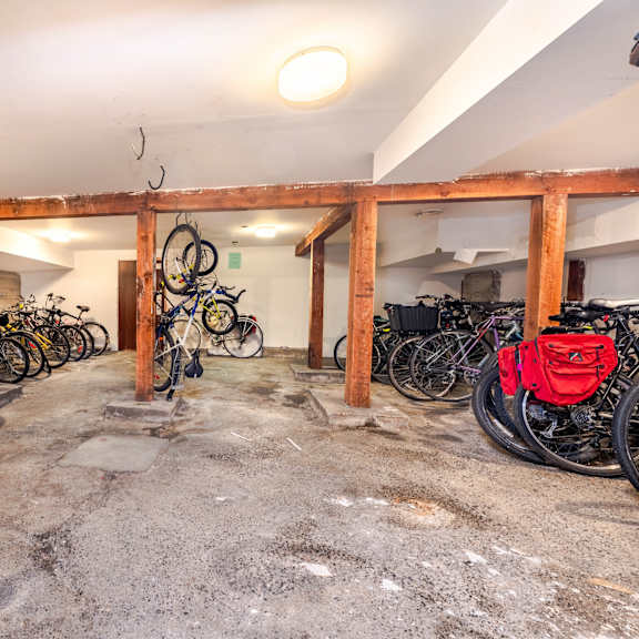 a bike rack with bicycles parked in a garage.