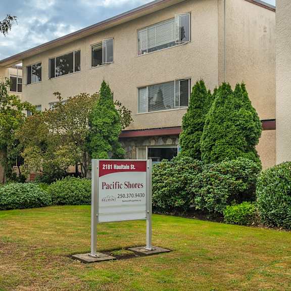 a sign for pacific shores is in front of a building.