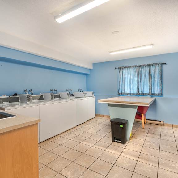 a kitchen with blue walls and white appliances.