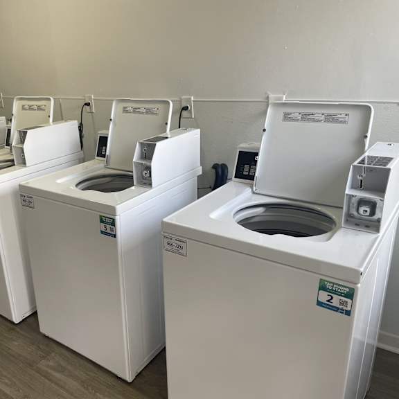 a row of washing machines in a laundromat