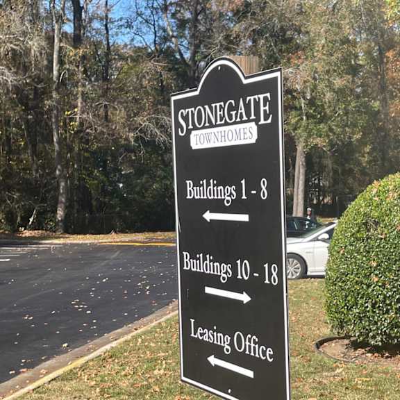 a sign in front of a road that says stonegate condos buildings 1 8 buildings 10 18