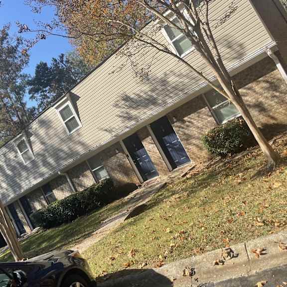 a building on a hill with a car parked in front of it