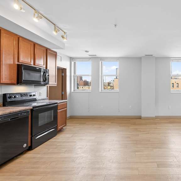 a kitchen with wooden cabinets and black appliances.
