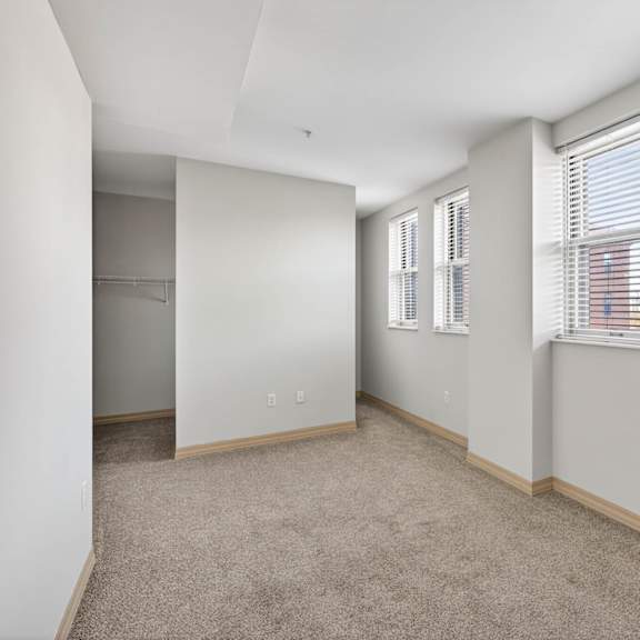 a room with a carpeted floor and a brown door.