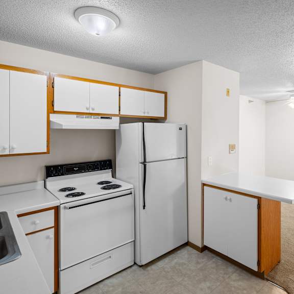 a kitchen with white appliances and cabinets.
