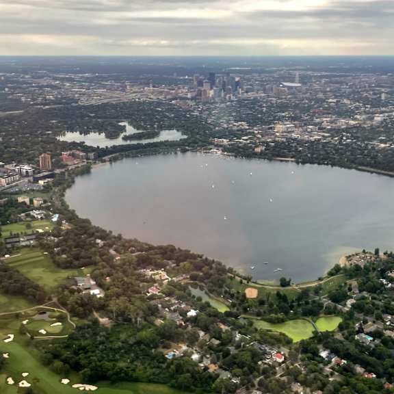 a large lake surrounded by a city and a golf course.