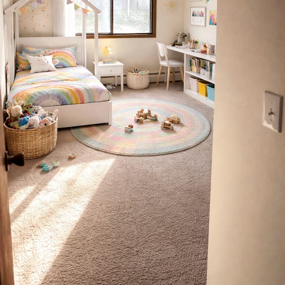 a child's bedroom with a bed, desk, chair, and toys.