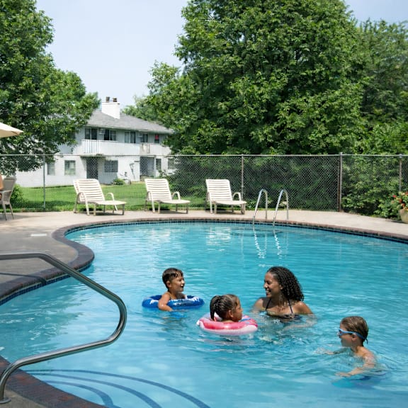 a group of people are enjoying a swim in a pool.