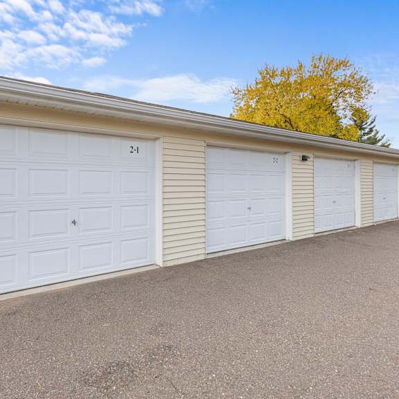 a row of white garage doors numbered from 21 to 24.