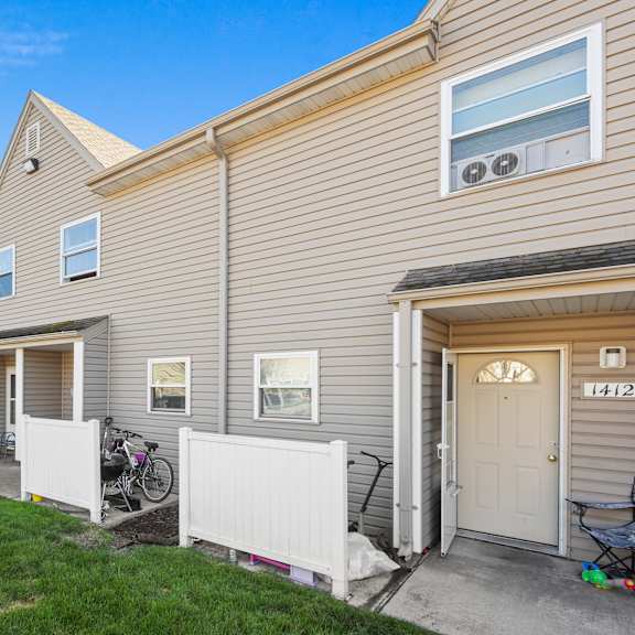 a row of houses with garages and bicycles parked outside.
