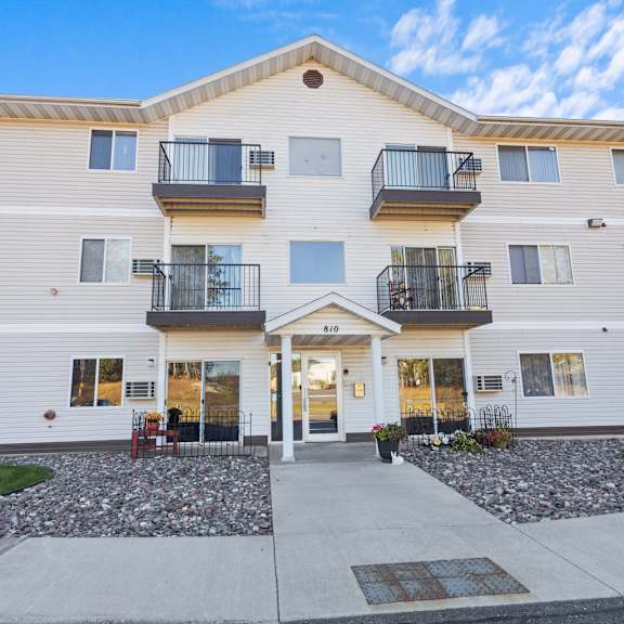 a two-story apartment building with a balcony on the second floor.