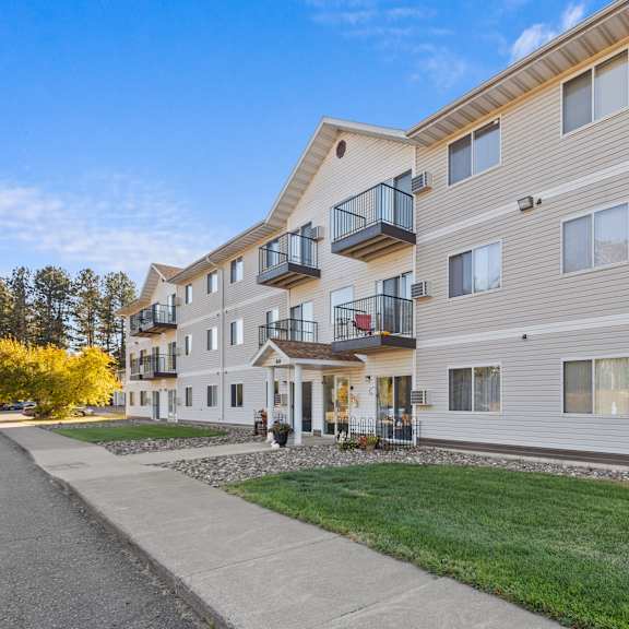 a modern apartment building with a balcony on the second floor.
