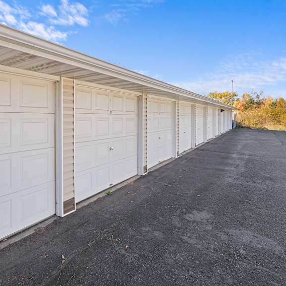 a long row of white garage doors are closed.