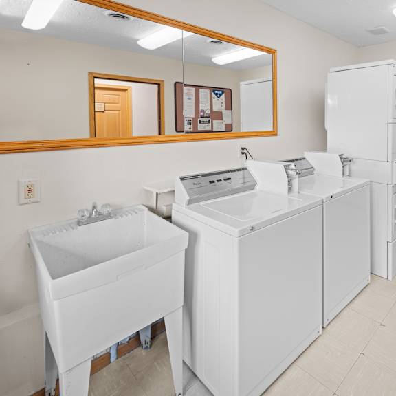 a white sink and a white cabinet are in a room.