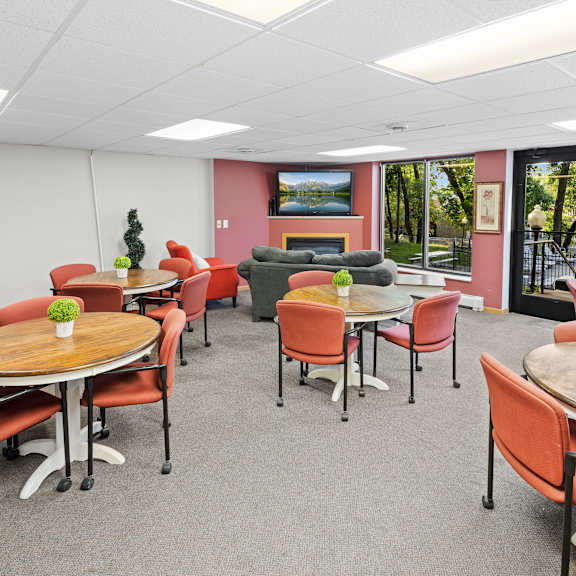 a conference room with a table surrounded by chairs.