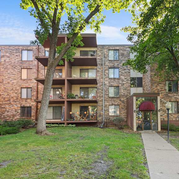 a brick building with a tree in front of it.