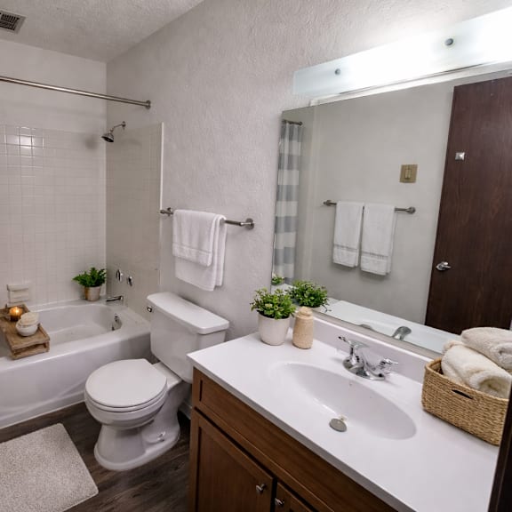 a bathroom with a toilet, sink, and bathtub.