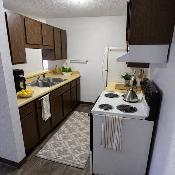 a small kitchen with a white stove top oven.