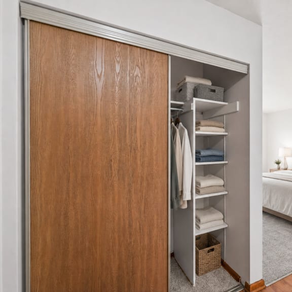 a bedroom with a large bed and a wooden wardrobe.