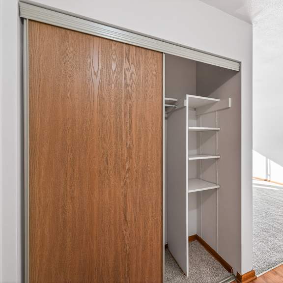 a brown door with a shelf underneath it.